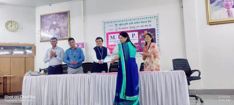 Archana Patil receiving a certificate at a Jalgaon entrepreneurship programme in 2024